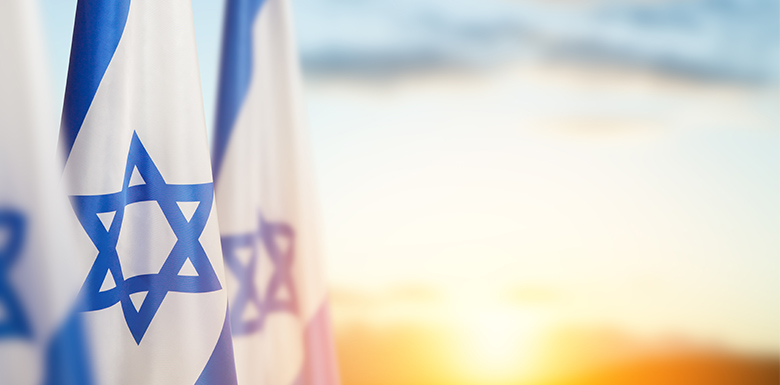 Israel flag with sunset in the background